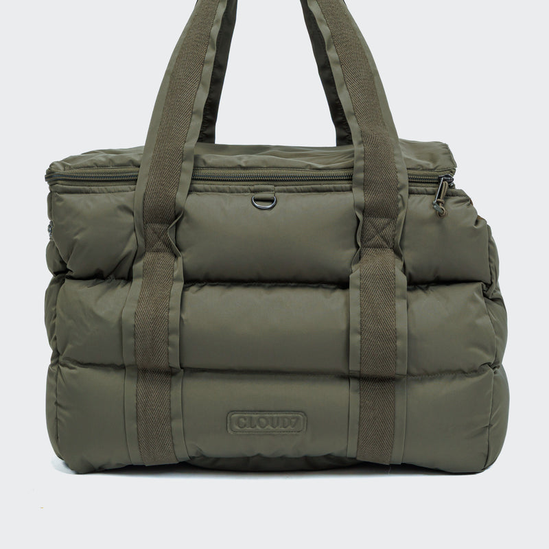 Green puffer duffel bag with visible brand logo on a light gray background