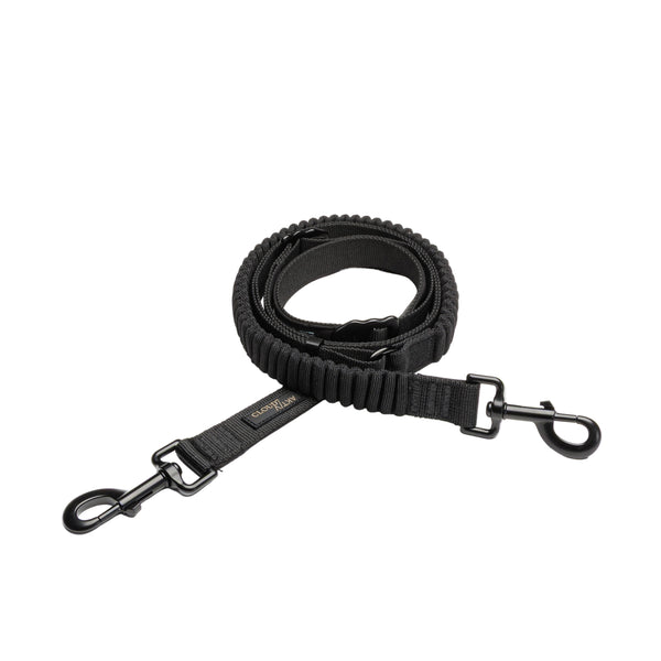 Black dog leash with metal clasp on a light gray background