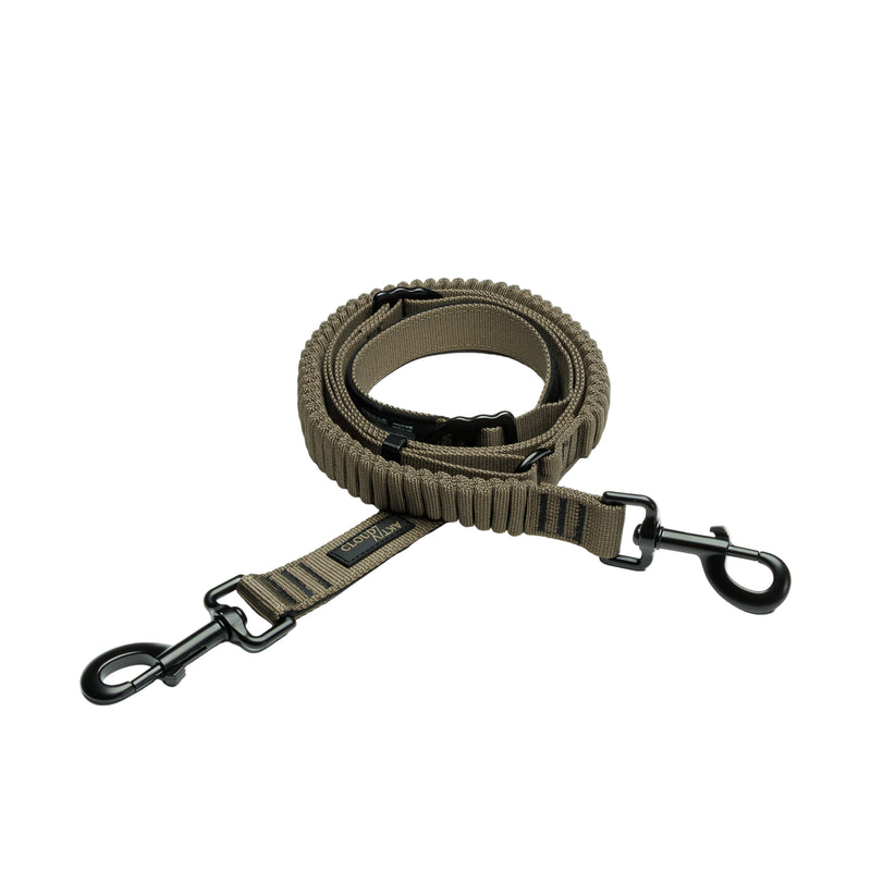Olive Green dog leash with black clips on a light gray background