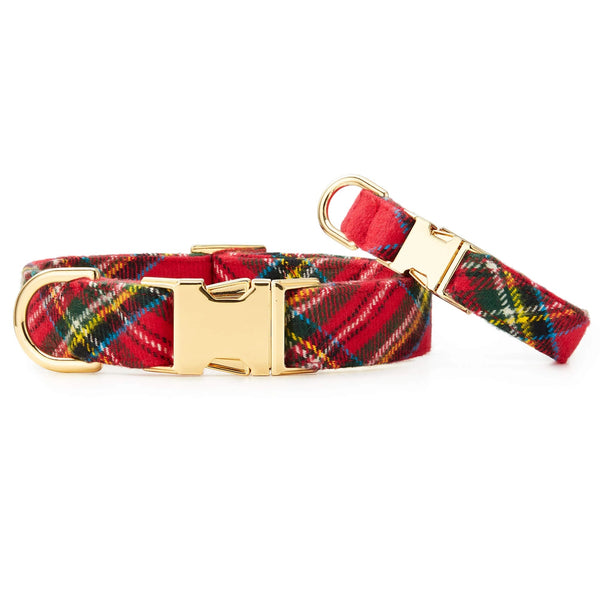 Red plaid dog collar with gold buckle on a white background