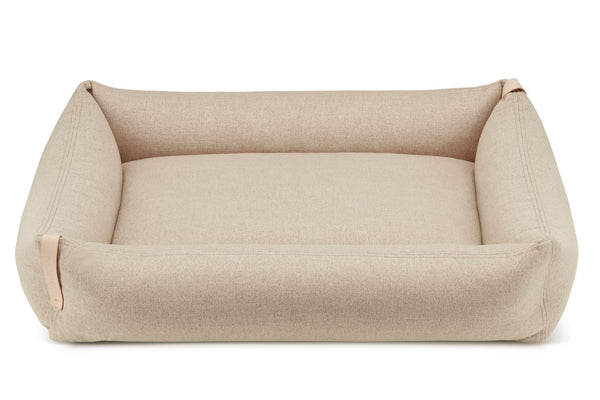 Beige pet bed on a white background