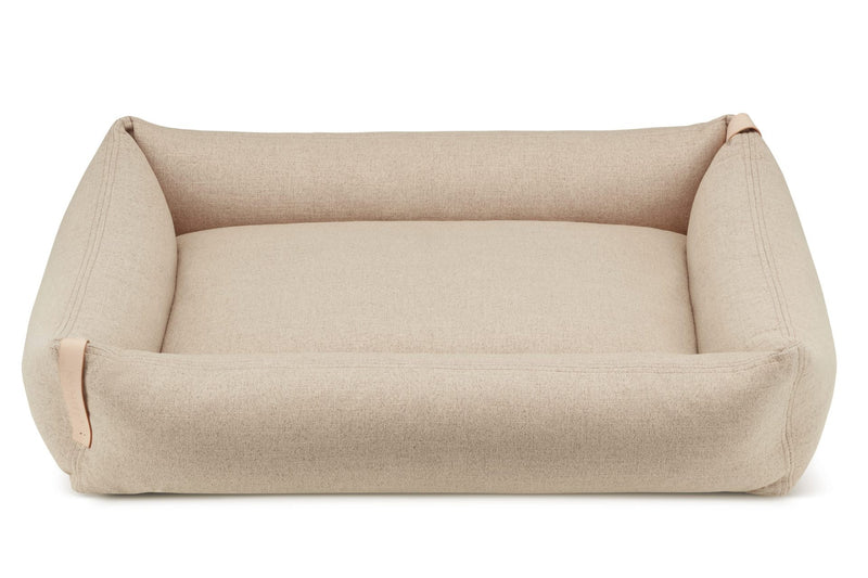 Beige pet bed on a white background